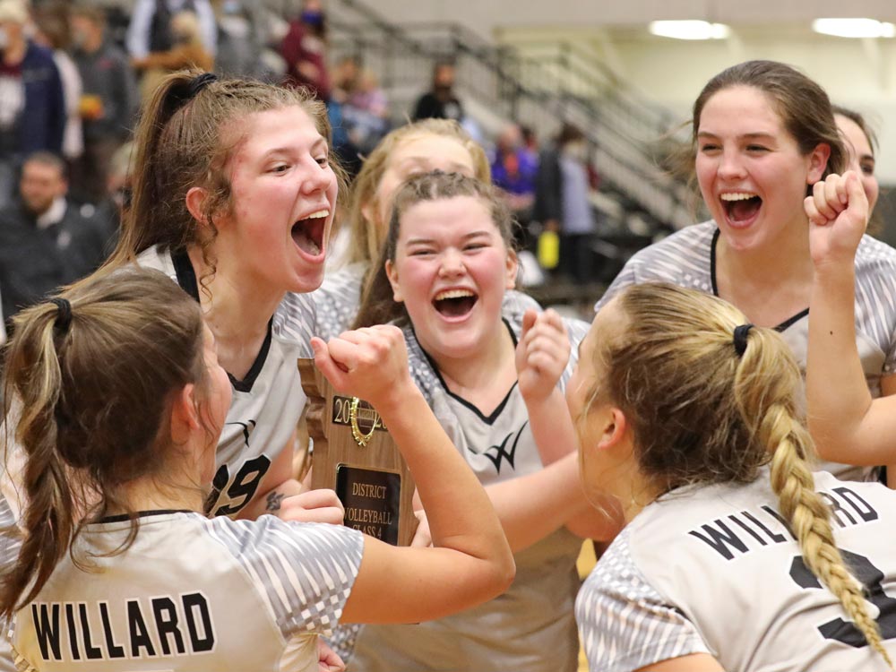 Willard volleyball players celebrate after beating Logan-Rogersville to win a seventh straight district championship.